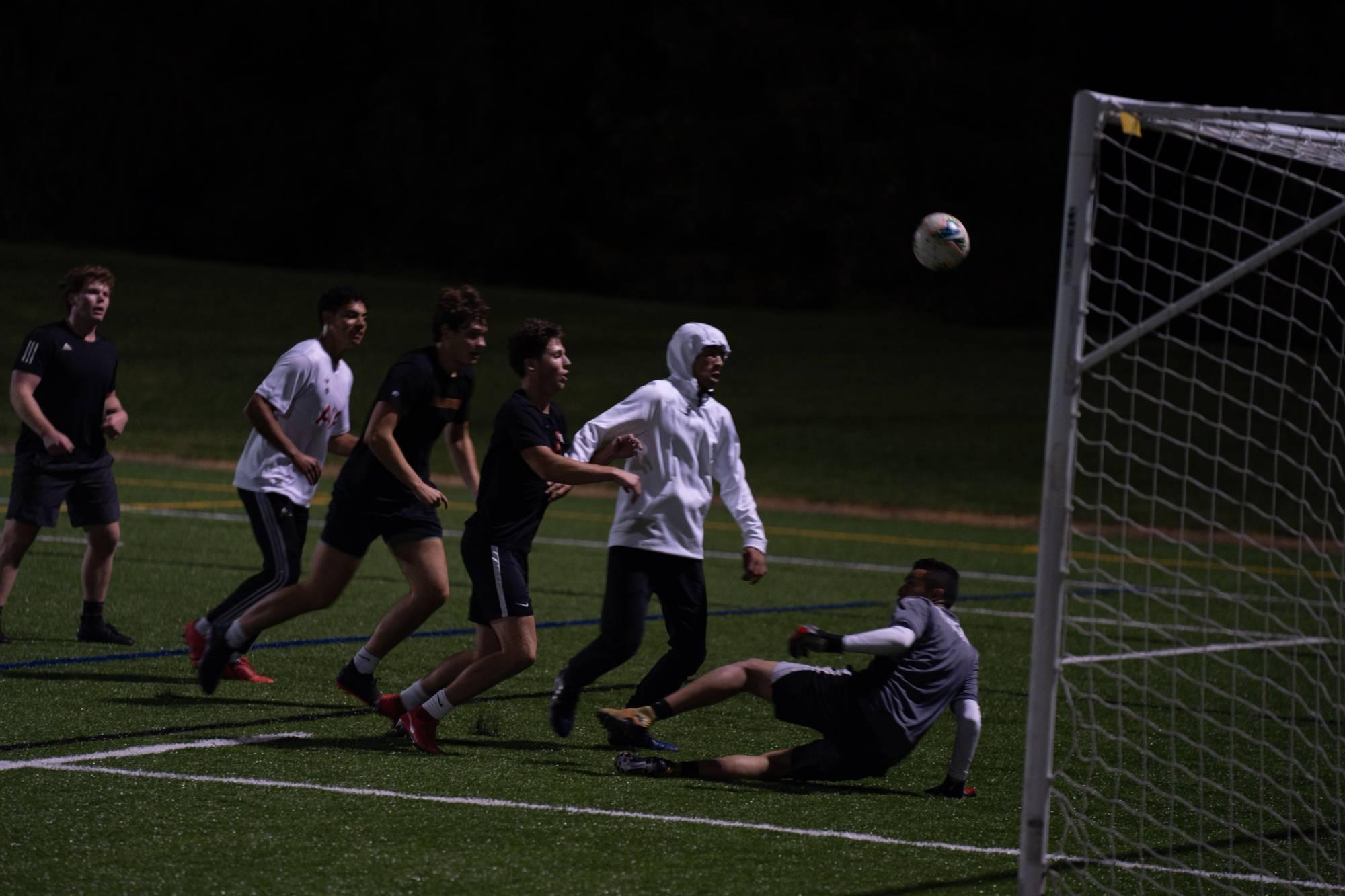 soccer players attempting to score a goal.